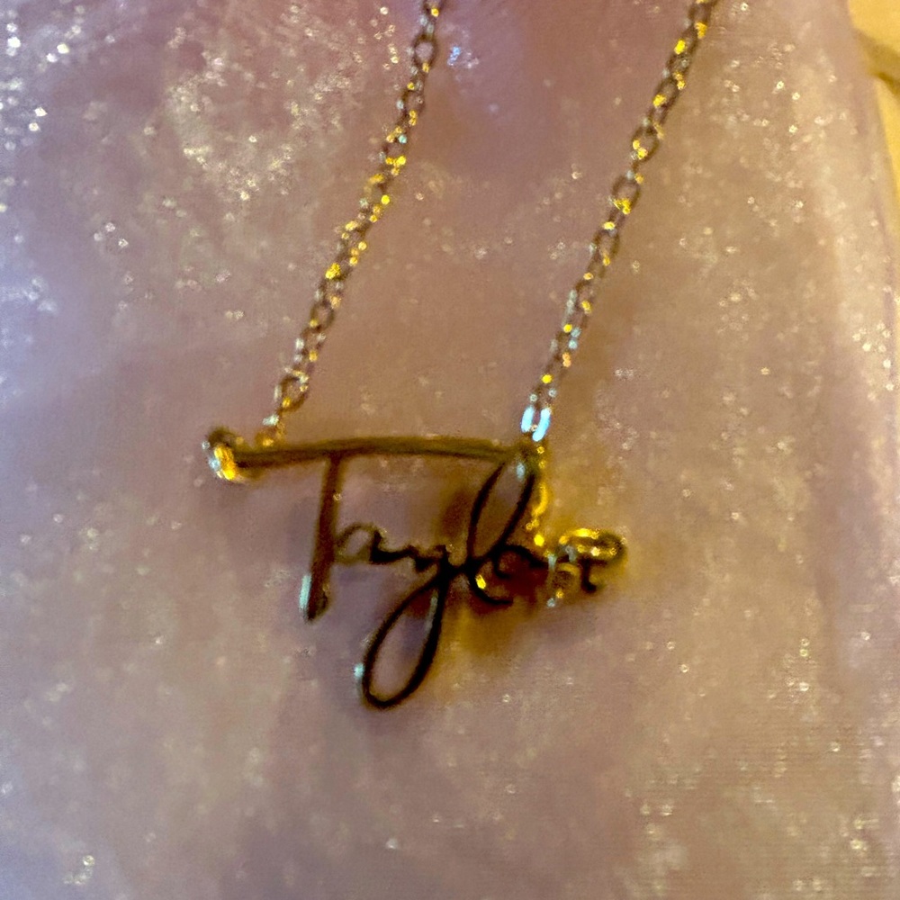 New - Taylor necklace for that special Taylor Swift fan. It is goldtone.